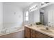 Bathroom with double vanity and a bathtub at 843 Challenger Ave, Davenport, FL 33897