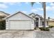 Gray house with two car garage and landscaping at 843 Challenger Ave, Davenport, FL 33897