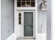 Gray front door with sidelights and storm door at 843 Challenger Ave, Davenport, FL 33897