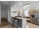 Bright kitchen with light cabinets, stainless steel appliances, and breakfast bar at 843 Challenger Ave, Davenport, FL 33897