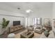 Living room with wood-look flooring, ceiling fan, and access to screened porch at 843 Challenger Ave, Davenport, FL 33897