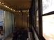 Enclosed patio with weight machine and string lights at 110 Cypress Woods Ct # 5C, Deltona, FL 32725