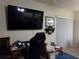 Home office features a large TV and sliding glass doors at 110 Cypress Woods Ct # 5C, Deltona, FL 32725