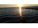 Stunning sunset over calm lake waters with a dock at 110 Cypress Woods Ct # 5C, Deltona, FL 32725