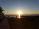 Scenic sunset view over the lake with people enjoying the outdoors at 110 Cypress Woods Ct # 5C, Deltona, FL 32725