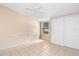 Bedroom with ceiling fan, window, and sliding door closet at 1103 Errol Place Cir, Apopka, FL 32712