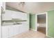 Updated kitchen with white cabinets and tile floors at 1103 Errol Place Cir, Apopka, FL 32712