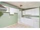 Updated kitchen with white cabinets and tile floors at 1103 Errol Place Cir, Apopka, FL 32712