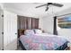 Main bedroom with floral bedding and ceiling fan at 1202 Dewey Ave, Orlando, FL 32808