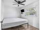 Simple bedroom with large bed, window, and ceiling fan at 1202 Dewey Ave, Orlando, FL 32808