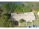 An aerial view of a townhome community featuring a brown roof, lush trees, and outdoor patio spaces at 1207 Lucaya Cir, Orlando, FL 32824