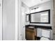 Clean bathroom with dark vanity and a large mirror at 1207 Lucaya Cir, Orlando, FL 32824