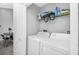 Laundry room with washer, dryer, and shelving at 1207 Lucaya Cir, Orlando, FL 32824