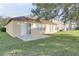 Home with a grassy backyard, patio, and sliding glass doors at 12755 Oulton Cir, Orlando, FL 32832