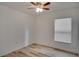 Well-lit bedroom with window, ceiling fan, and wood-look floors at 12755 Oulton Cir, Orlando, FL 32832