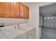 Laundry room with washer, dryer, cabinets, and garage access at 12755 Oulton Cir, Orlando, FL 32832