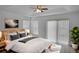 Cozy bedroom featuring a tray ceiling, large windows, and neutral decor at 12755 Oulton Cir, Orlando, FL 32832