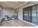 Cozy screened porch with wicker furniture and string lights at 1420 Queen Elaine Dr, Casselberry, FL 32707