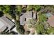 Aerial shot of the home, roof, and backyard, surrounded by lush trees at 203 Red Bud Ln, Longwood, FL 32779