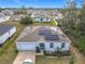 One-story house with solar panels, driveway and neighborhood view at 208 Goldenrod Ln, Kissimmee, FL 34759