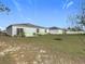 Large backyard with grassy area and home at 208 Goldenrod Ln, Kissimmee, FL 34759