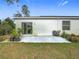 Home's backyard with patio and landscaping at 208 Goldenrod Ln, Kissimmee, FL 34759