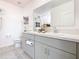 Modern bathroom with double vanity, gray cabinets, and a large mirror at 208 Goldenrod Ln, Kissimmee, FL 34759