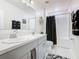 Bathroom with double vanity, shower, and bathtub at 208 Goldenrod Ln, Kissimmee, FL 34759