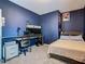 Bedroom with a double bed, a workspace with a computer, and navy walls at 208 Goldenrod Ln, Kissimmee, FL 34759