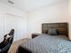 Bedroom with double bed, closet, and gaming chair at 208 Goldenrod Ln, Kissimmee, FL 34759
