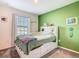 Bedroom with a white bed frame and green accent wall at 208 Goldenrod Ln, Kissimmee, FL 34759