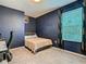 Simple bedroom with a double bed, navy blue walls, and a window with curtains at 208 Goldenrod Ln, Kissimmee, FL 34759
