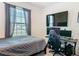 Bedroom with a double bed, gaming setup, and a large window at 208 Goldenrod Ln, Kissimmee, FL 34759