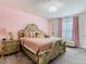 Spacious bedroom with large bed, pink walls and window with curtains at 208 Goldenrod Ln, Kissimmee, FL 34759