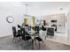 Elegant dining room features a glass table with black chairs and a modern chandelier at 208 Goldenrod Ln, Kissimmee, FL 34759