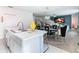 Modern kitchen with island, view into dining and living areas at 208 Goldenrod Ln, Kissimmee, FL 34759