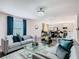 Open living space with gray sofas, a large TV and stylish decor at 208 Goldenrod Ln, Kissimmee, FL 34759