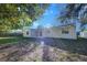 Sunny backyard with grassy lawn and patio area at 209 Meadow Hills Dr, Sanford, FL 32773
