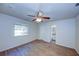Bedroom with wood-look flooring, ceiling fan and en-suite bathroom at 209 Meadow Hills Dr, Sanford, FL 32773