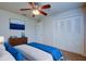 Cozy bedroom featuring plush bedding, a ceiling fan, and a closet for ample storage at 209 Meadow Hills Dr, Sanford, FL 32773