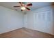 Well-lit bedroom featuring a ceiling fan and built-in closet at 209 Meadow Hills Dr, Sanford, FL 32773