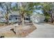 Newly painted single story home with mature landscaping and a driveway at 209 Meadow Hills Dr, Sanford, FL 32773