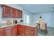 Open kitchen layout with granite countertops, cherry cabinets, and a dining area for casual meals at 209 Meadow Hills Dr, Sanford, FL 32773