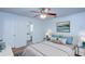 Comfortable main bedroom with large bed, ceiling fan and view into ensuite bathroom at 209 Meadow Hills Dr, Sanford, FL 32773