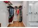 Walk-in closet with hanging rods, shelves and wood floor at 2910 Black Birch Dr, Ocoee, FL 34761