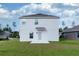 Rear view of two-story home with backyard at 2910 Black Birch Dr, Ocoee, FL 34761
