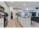Modern kitchen with white cabinets, center island, and stainless appliances at 2910 Black Birch Dr, Ocoee, FL 34761