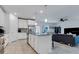 Modern kitchen with white cabinets, island, and stainless steel appliances at 2910 Black Birch Dr, Ocoee, FL 34761