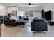 Open living area with sectional sofa, large TV, and tile floors at 2910 Black Birch Dr, Ocoee, FL 34761