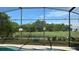 Screened patio overlooking a fenced backyard with trees at 3022 Bransbury Ct, Kissimmee, FL 34747